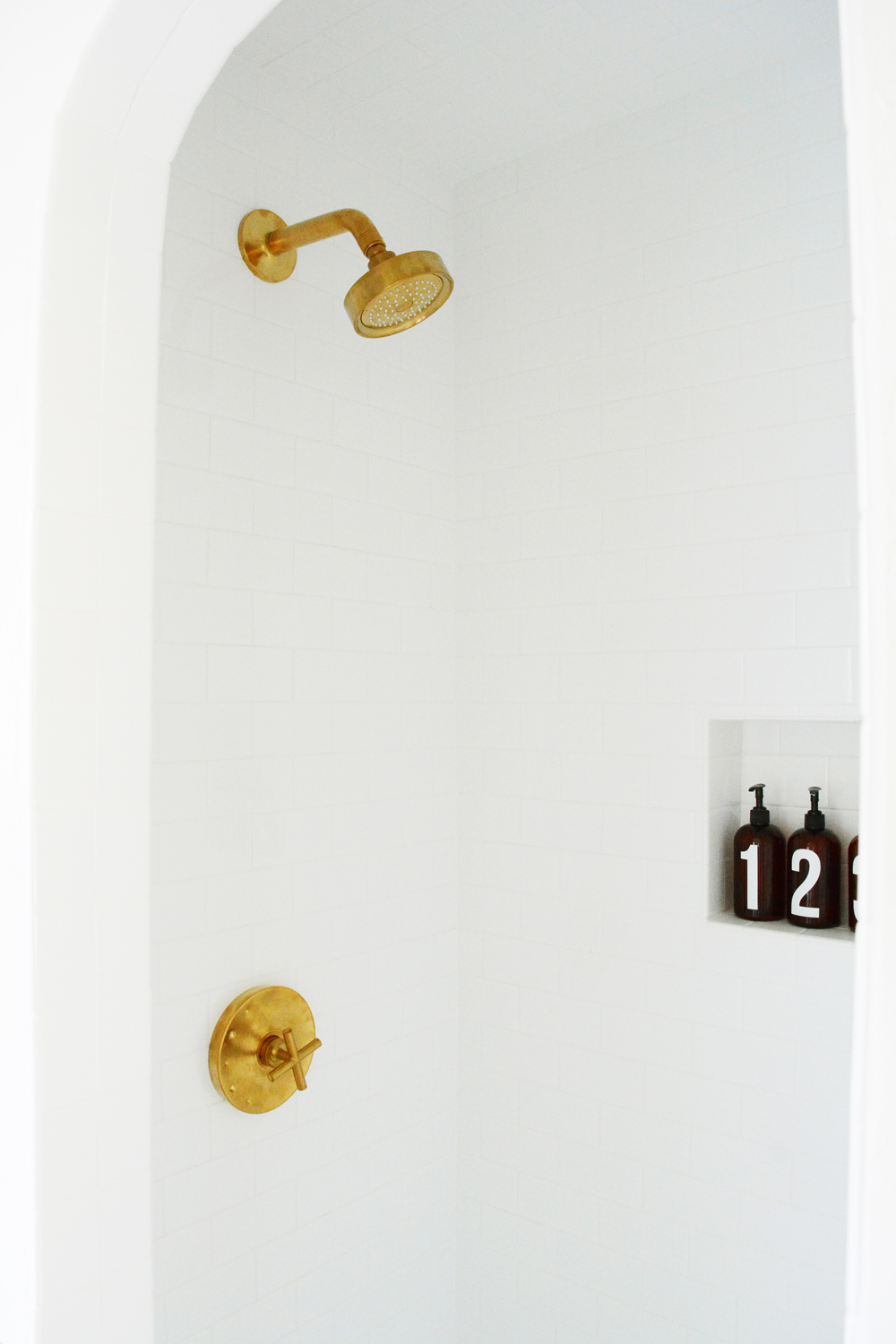 Guesthouse Bathroom Reveal - Bold patterns, crisp clean white tile, and brass fixtures. 